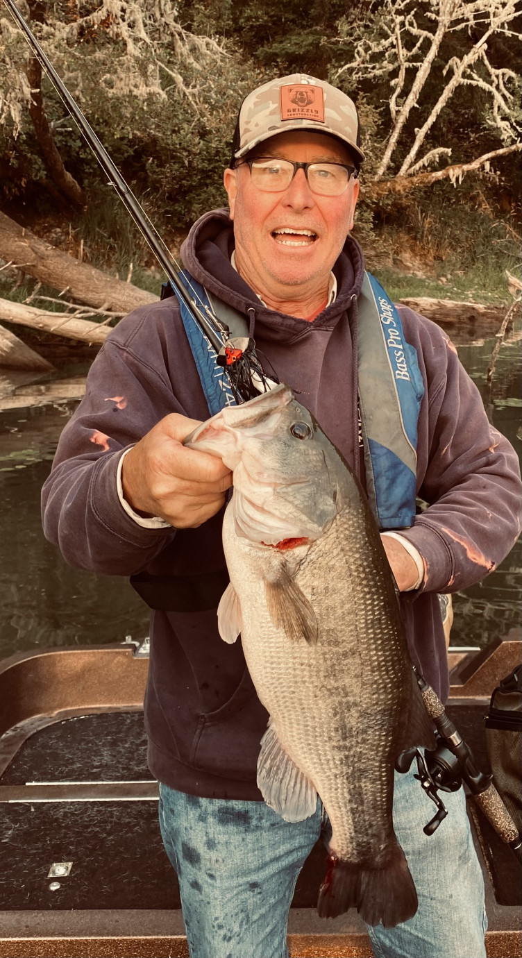 Dean holding a large bass called "big girl"